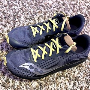 Gray and yellow saucony running spikes.